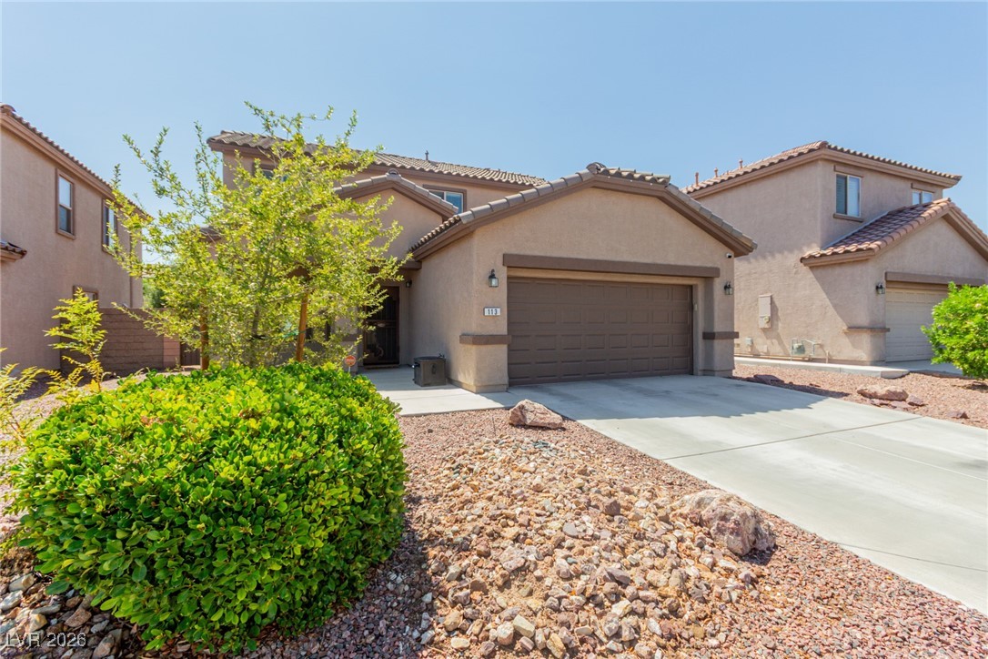 113 Lovage Street Henderson, NV 89002 - Photo 7 of 27 Mediterranean / spanish house featuring stucco siding, concrete driveway, an attached garage, and a tiled roof