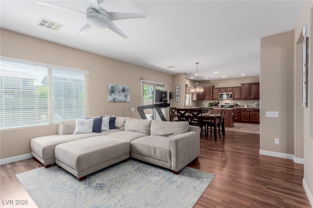 113 Lovage Street Henderson, NV 89002 - Photo 10 of 27 Living room with recessed lighting, a ceiling fan, dark wood finished floors, and a chandelier