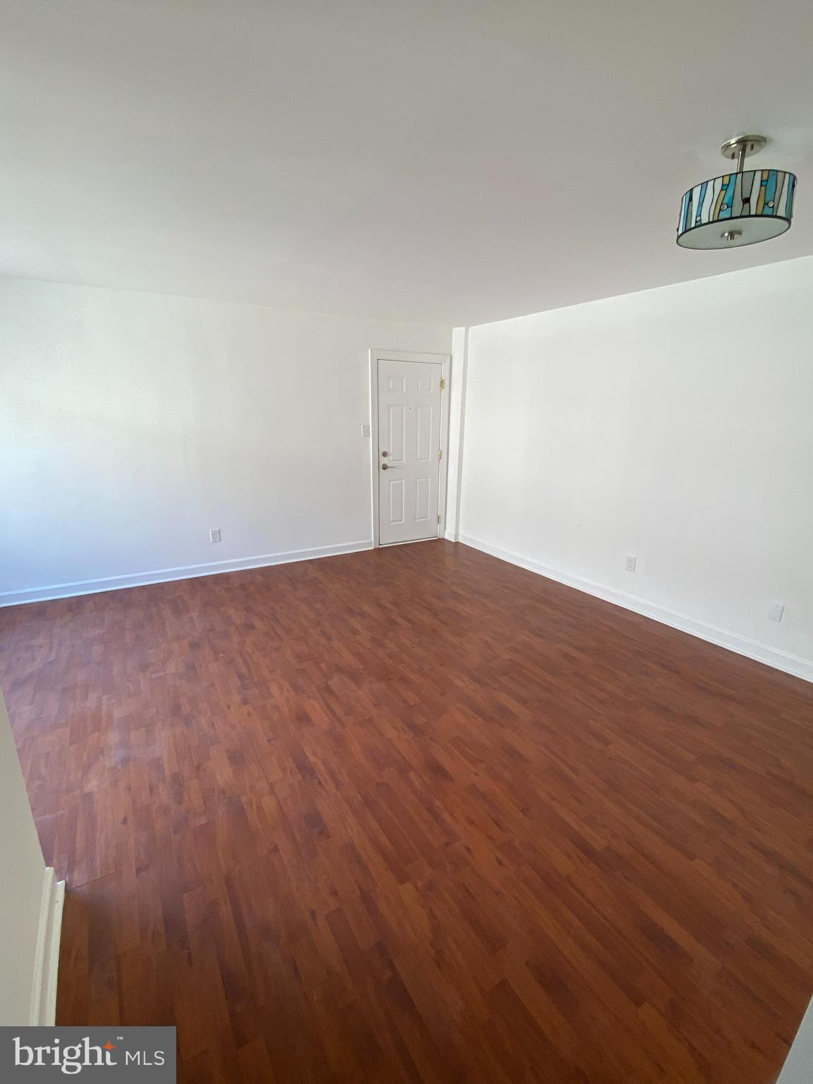 701 Brandywine Street Southeast, Unit 201 Washington, DC 20032 - Photo 5 of 18 an empty room with wooden floor