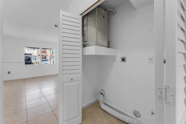 an empty room with window and a ceiling fan