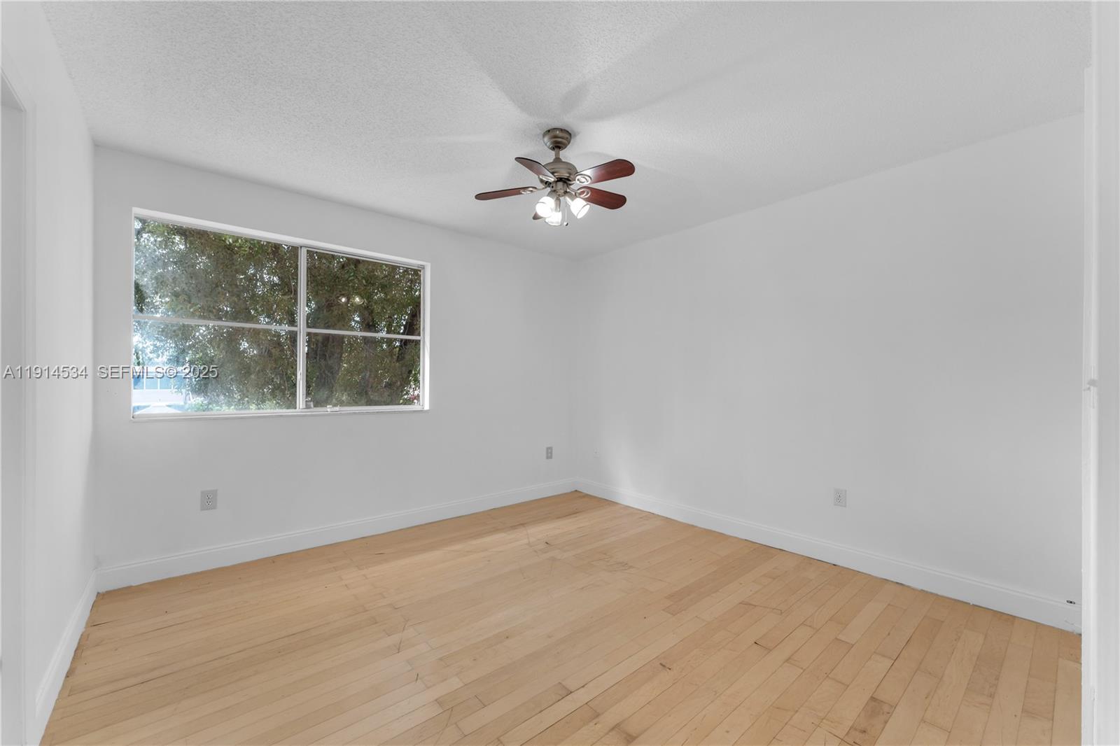 6350 Southwest 139th Avenue Miami, FL 33183 - Photo 15 of 37 an empty room with a window and ceiling fan