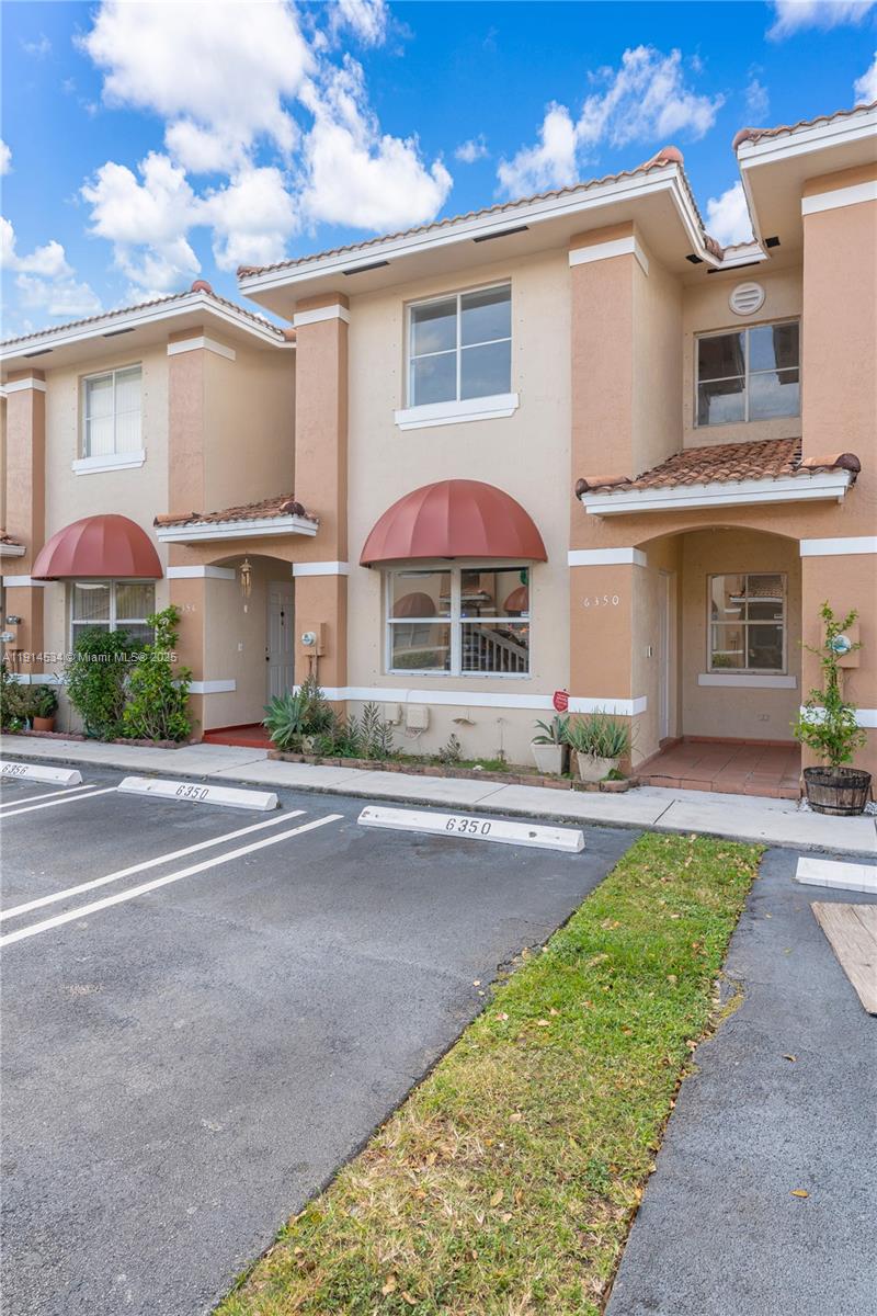 6350 Southwest 139th Avenue Miami, FL 33183 - Photo 2 of 37 a front view of a house with a yard and potted plants