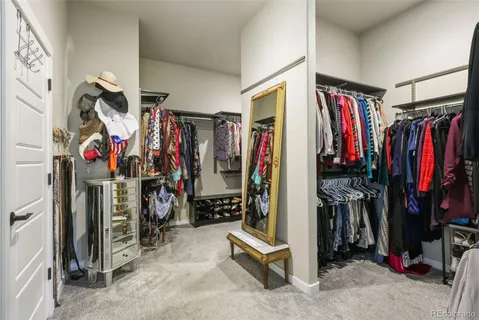 a view of walk in closet with clothes