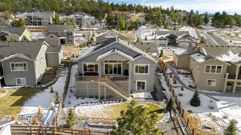a view of a white house with a large pool and lawn chairs