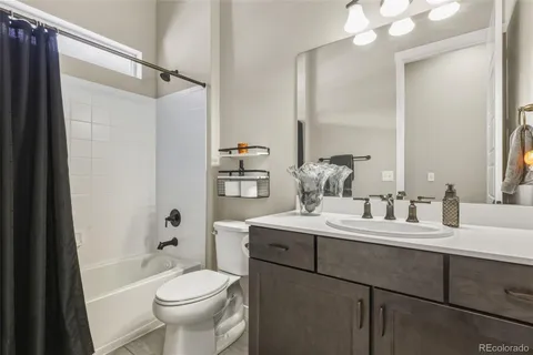 a bathroom with a sink toilet tub and shower