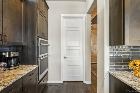 a kitchen with stainless steel appliances granite countertop a stove and a refrigerator