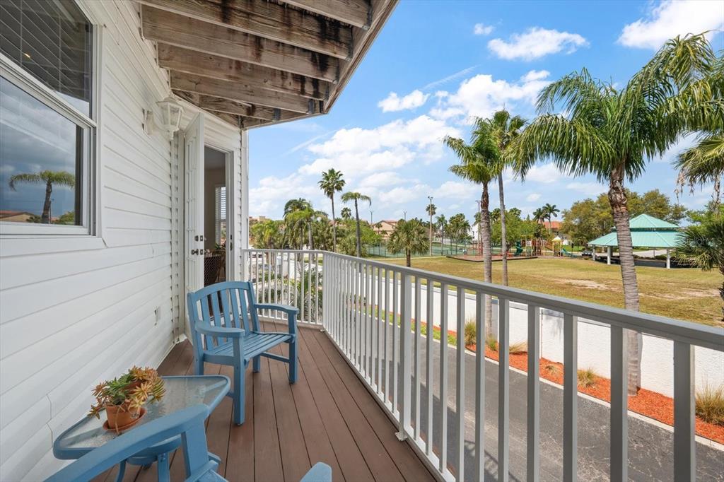 103 Shoals Circle North Redington Beach, FL 33708 - Photo 12 of 69 a view of a chair and tables in the balcony
