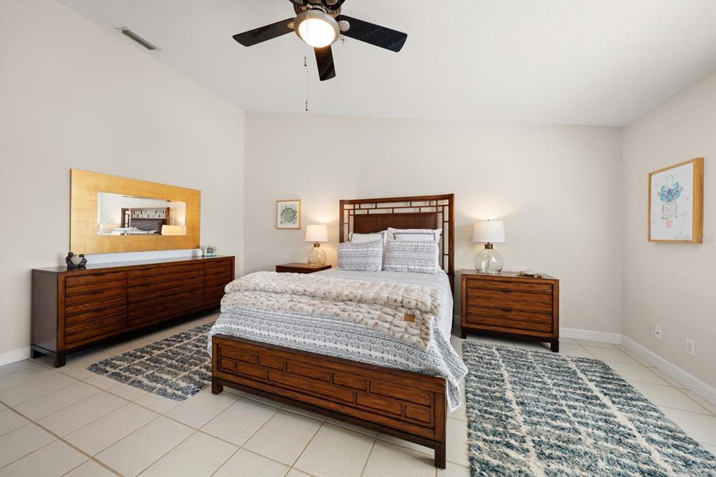 103 Shoals Circle North Redington Beach, FL 33708 - Photo 30 of 69 a bedroom with a bed and wooden floor