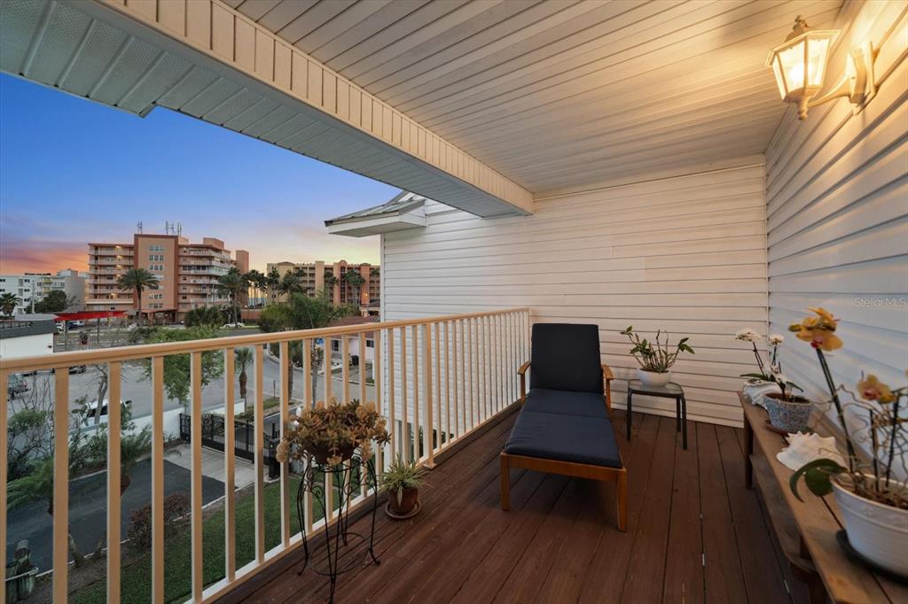 103 Shoals Circle North Redington Beach, FL 33708 - Photo 35 of 69 a view of a balcony with chairs and wooden fence