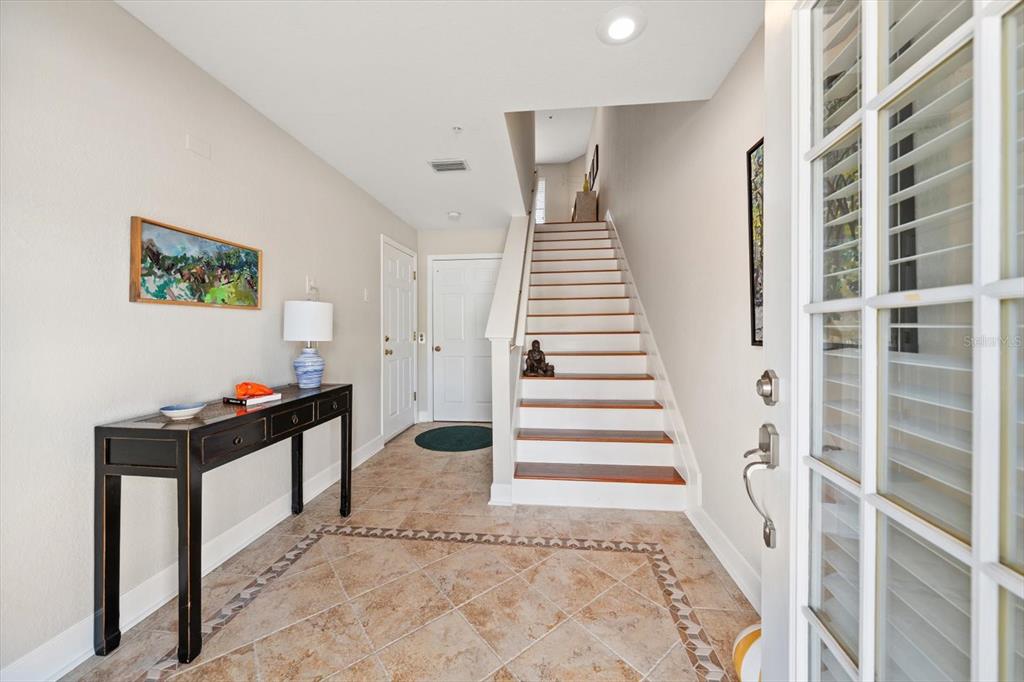 103 Shoals Circle North Redington Beach, FL 33708 - Photo 5 of 69 a view of a hallway with paintings on the walls