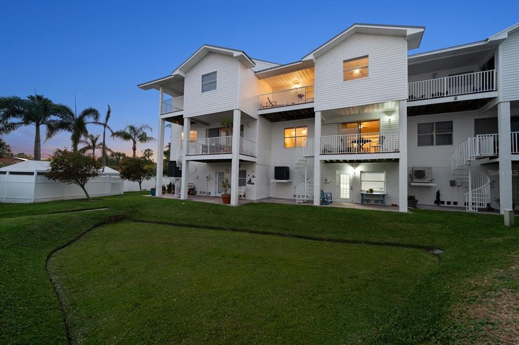 103 Shoals Circle North Redington Beach, FL 33708 - Photo 59 of 69 a front view of a house with a garden and yard