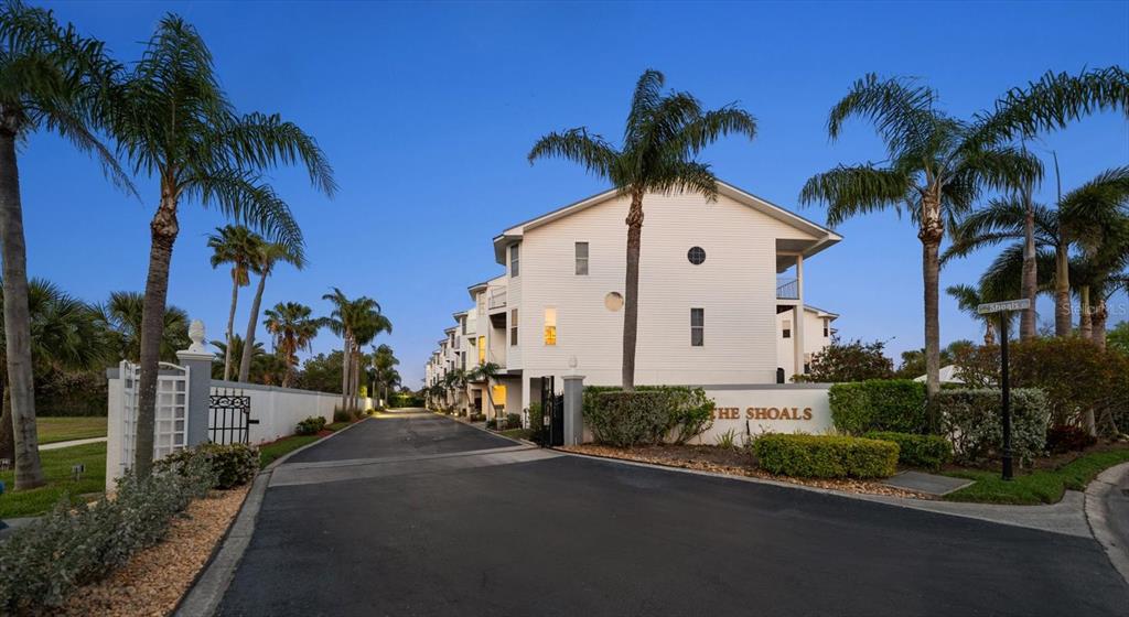 103 Shoals Circle North Redington Beach, FL 33708 - Photo 62 of 69 a front view of a house with a yard and garage