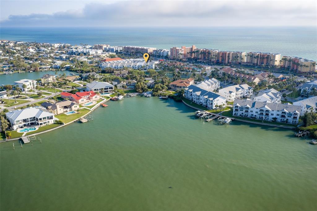 103 Shoals Circle North Redington Beach, FL 33708 - Photo 65 of 69 an aerial view of a city with lots of residential buildings ocean and mountain view in back