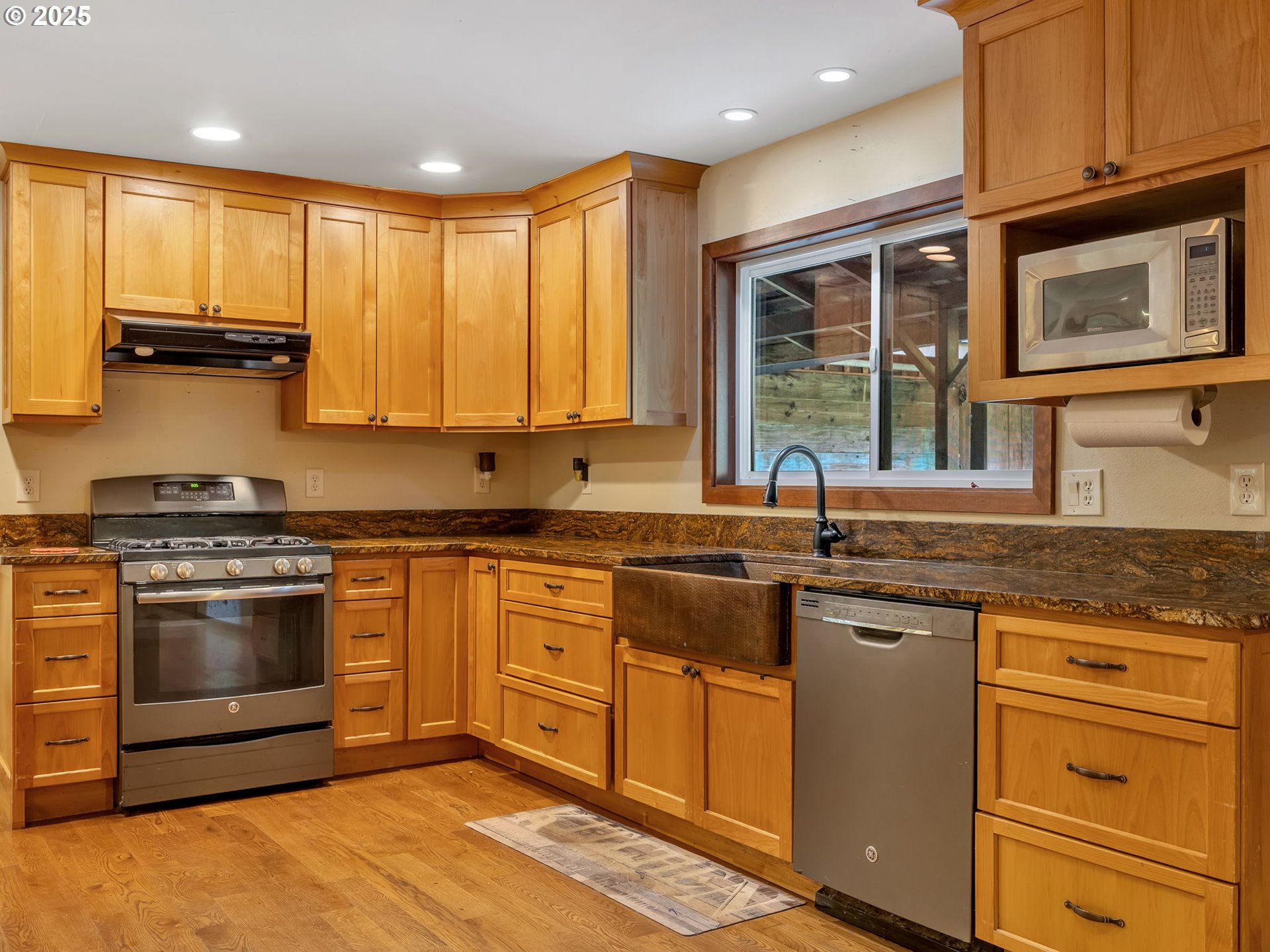 42274 Ziak-Gnat Creek Road Astoria, OR 97103 - Photo 15 of 48 a kitchen with stainless steel appliances granite countertop a stove a sink and a microwave