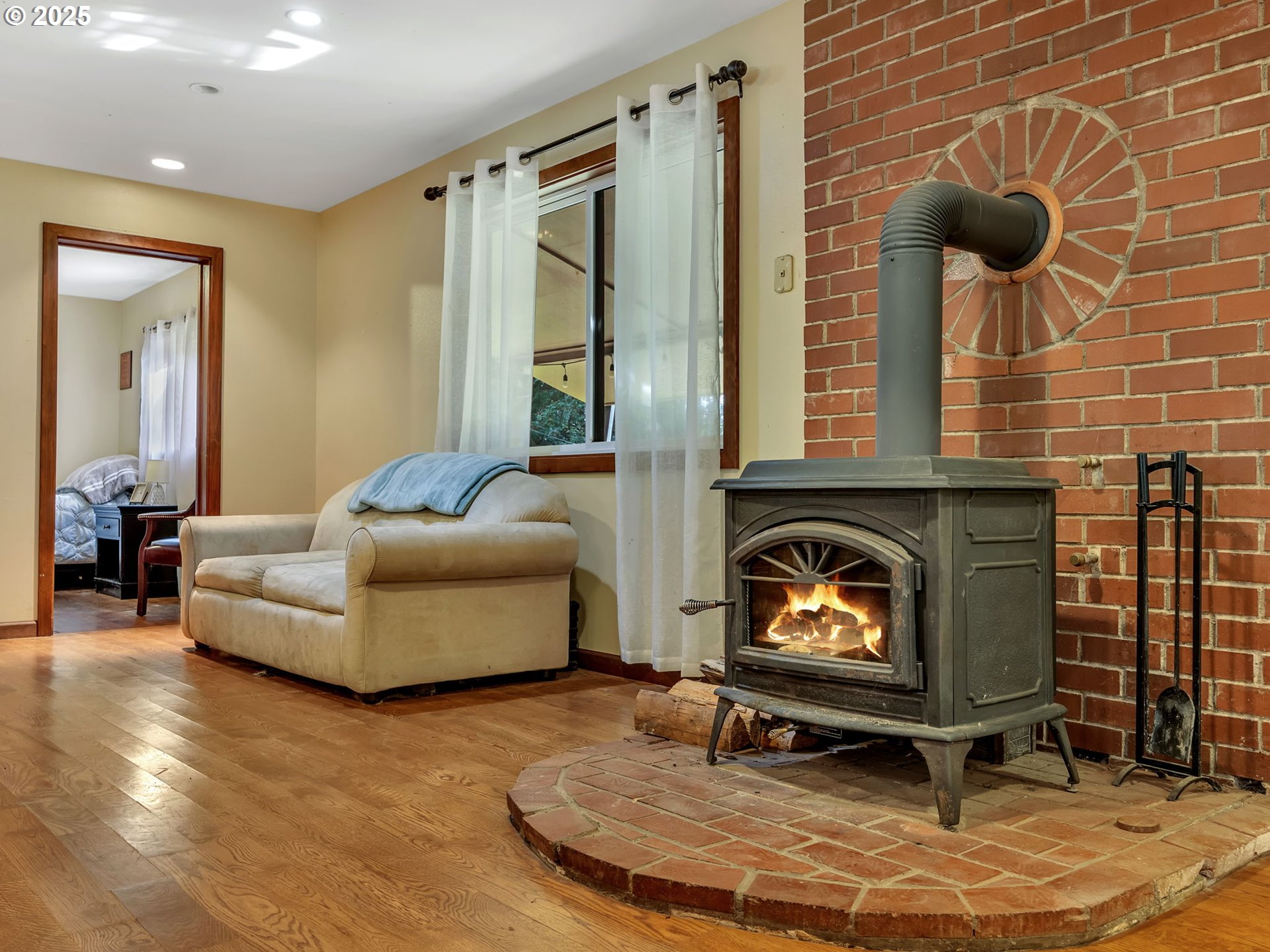 42274 Ziak-Gnat Creek Road Astoria, OR 97103 - Photo 23 of 48 a living room with furniture and a fireplace
