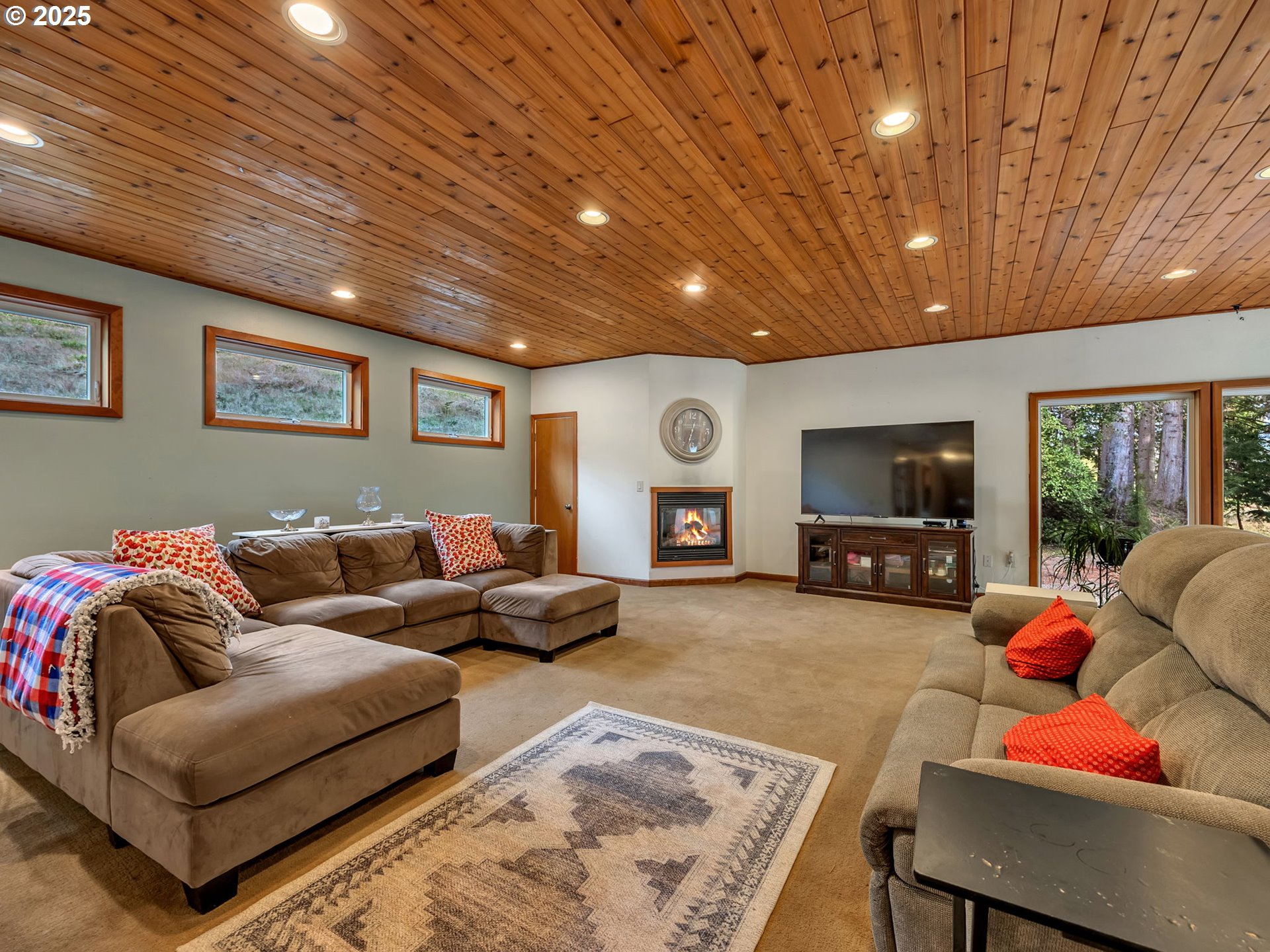 42274 Ziak-Gnat Creek Road Astoria, OR 97103 - Photo 7 of 48 a living room with furniture a flat screen tv and a table