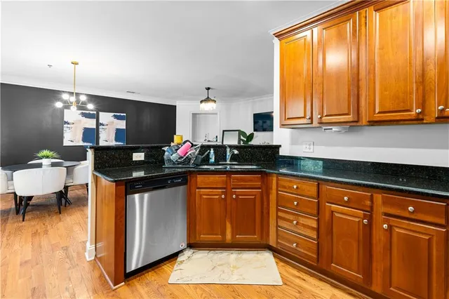 a kitchen with stainless steel appliances granite countertop a sink and a stove