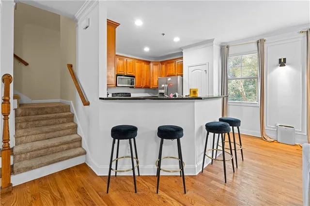 a view of kitchen with cabinets and wooden floor