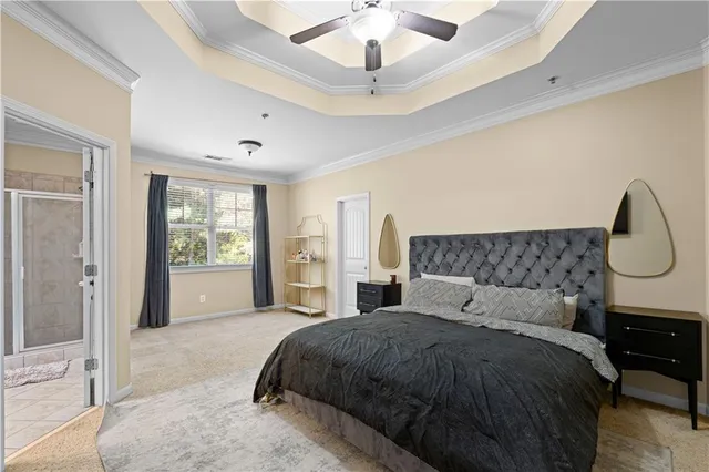 a spacious bedroom with a bed and a chandelier