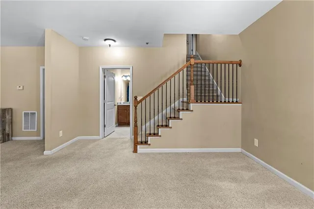 a view of an empty room with stairs