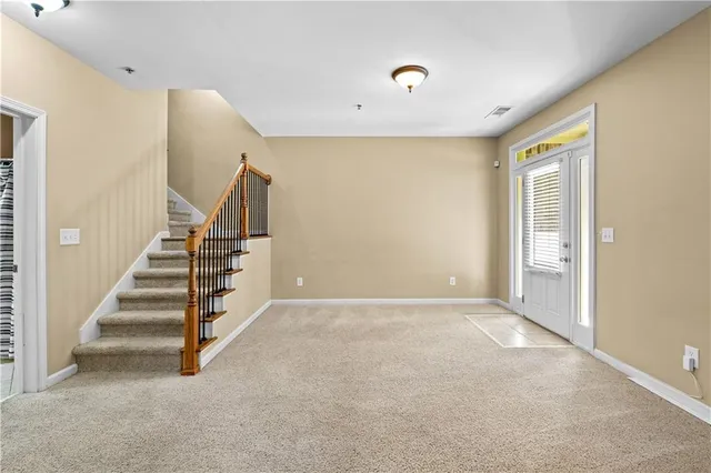 a view of a livingroom with furniture and stairs