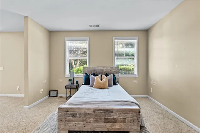 a bedroom with a large bed and a chandelier