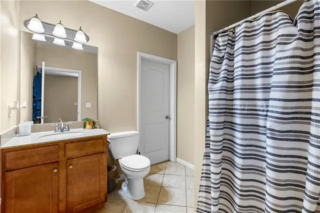 a bathroom with a sink mirror vanity and toilet