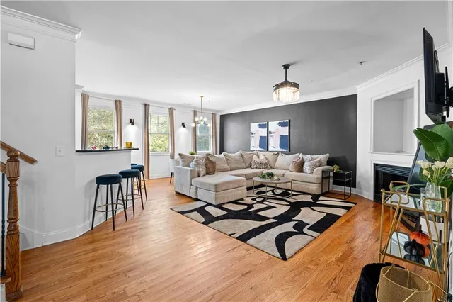 a living room with furniture flat screen tv and a fireplace