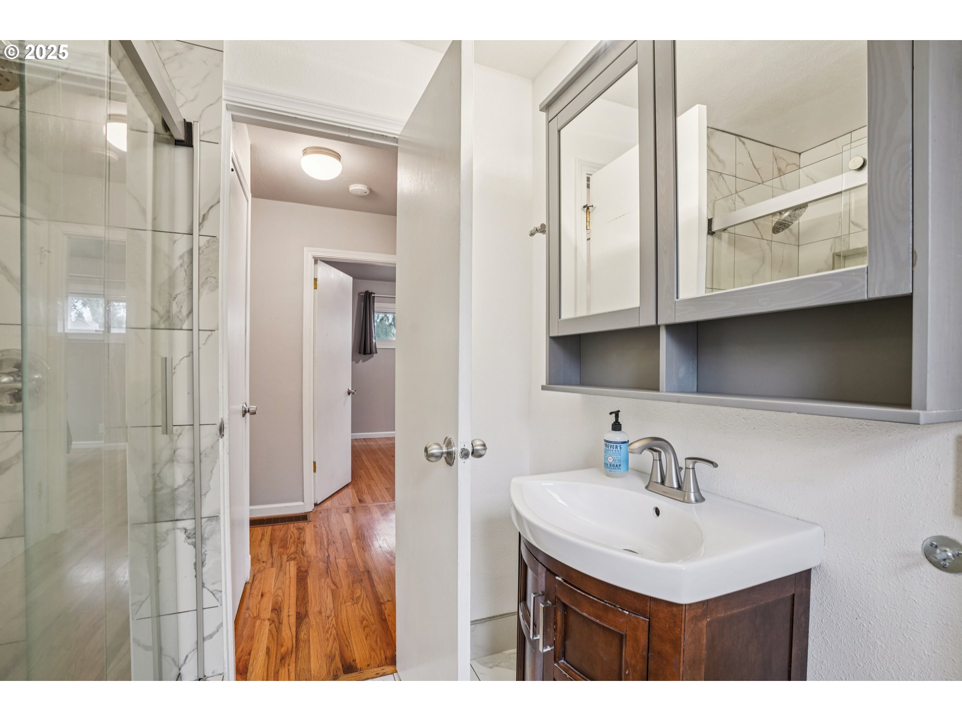 14806 Southeast Bush Street Portland, OR 97236 - Photo 12 of 33 a bathroom with a sink a mirror and shower