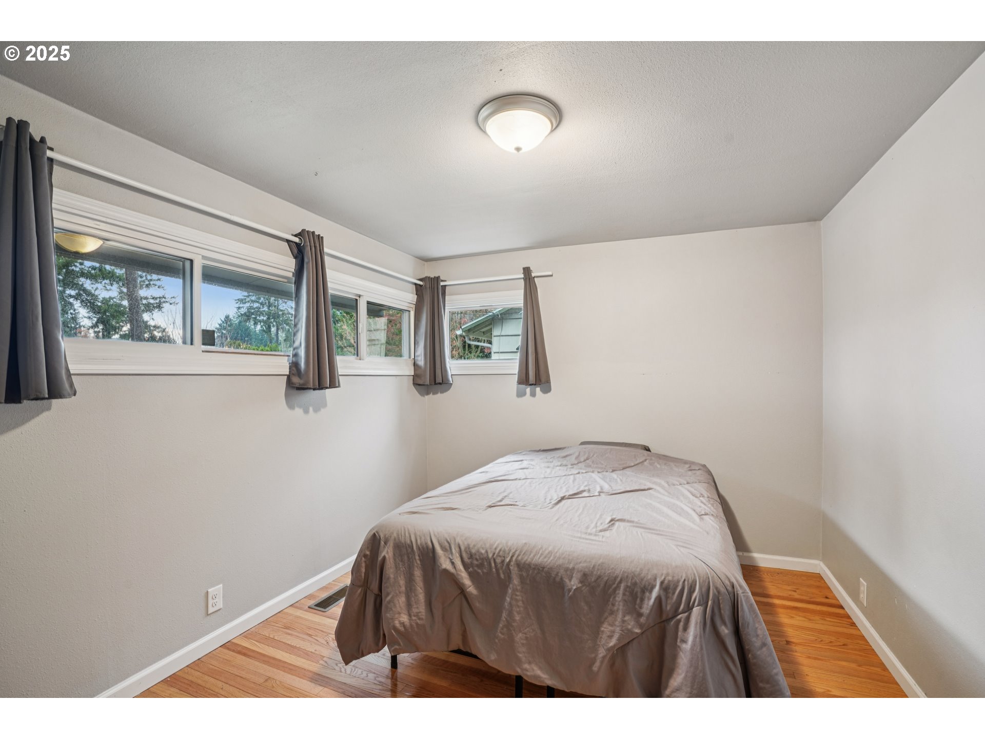 14806 Southeast Bush Street Portland, OR 97236 - Photo 13 of 33 a bedroom with a bed and a window