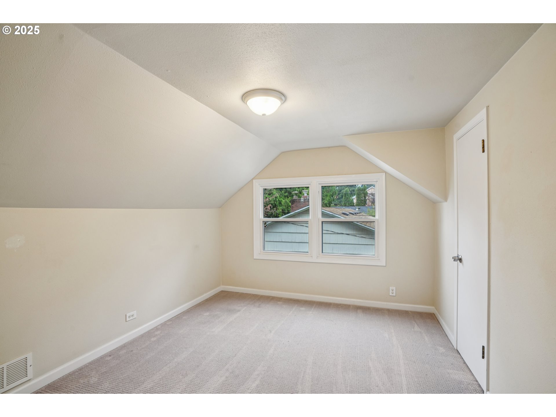 14806 Southeast Bush Street Portland, OR 97236 - Photo 15 of 33 an empty room with wooden floor and windows