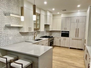 1574 Beacon Street, Unit U: PH2 Brookline, MA 02446 - Photo 2 of 11 a kitchen with a sink a stove and cabinets