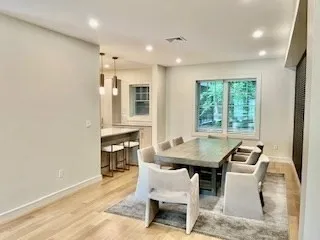 a dining room with furniture and window