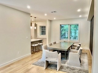 1574 Beacon Street, Unit U: PH2 Brookline, MA 02446 - Photo 4 of 11 a dining room with furniture and window