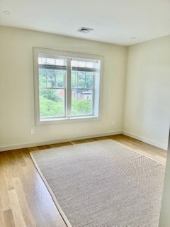 1574 Beacon Street, Unit U: PH2 Brookline, MA 02446 - Photo 10 of 11 an empty room with a window