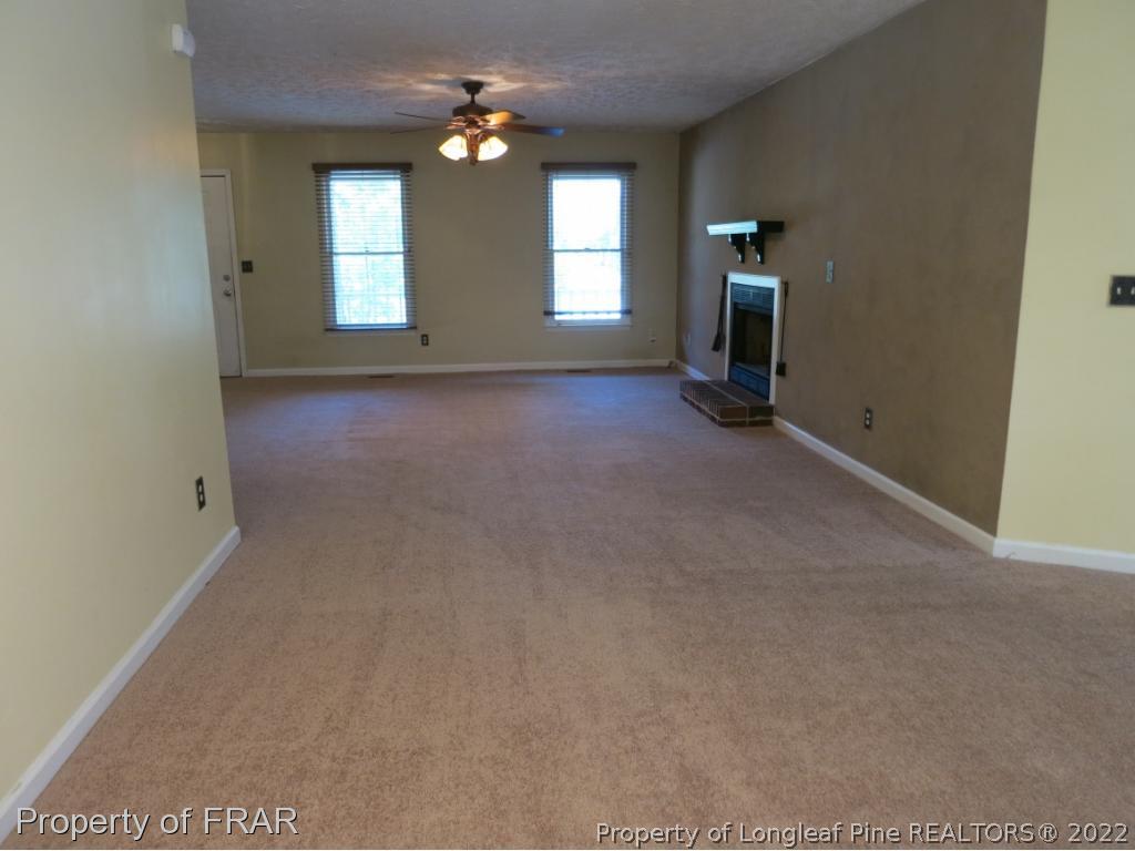 6875 Green Creek Road Fayetteville, NC 28314 - Photo 12 of 26 an empty room with windows and fireplace