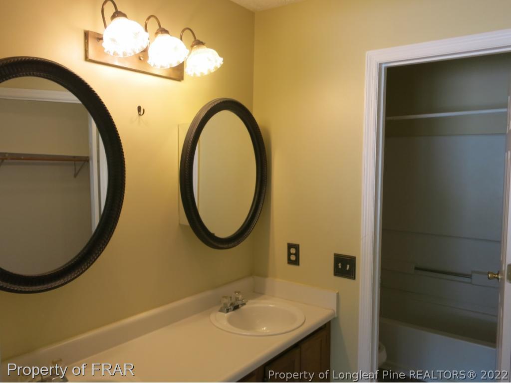 6875 Green Creek Road Fayetteville, NC 28314 - Photo 15 of 26 a bathroom with a sink and a mirror