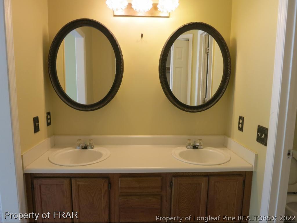 6875 Green Creek Road Fayetteville, NC 28314 - Photo 16 of 26 a bathroom with a sink and a mirror