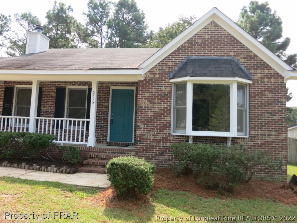 6875 Green Creek Road Fayetteville, NC 28314 - Photo 2 of 26 a view of a brick house with plants and many windows