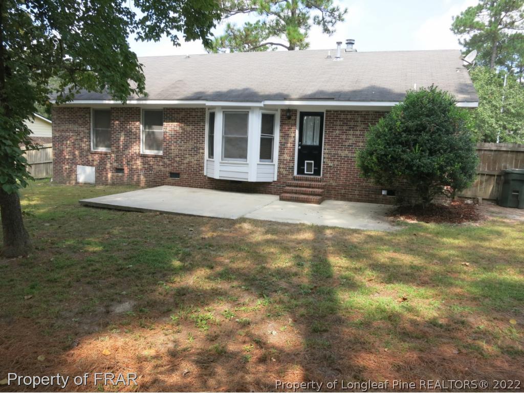 6875 Green Creek Road Fayetteville, NC 28314 - Photo 22 of 26 a backyard of a house with table and chairs