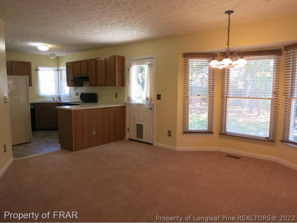 6875 Green Creek Road Fayetteville, NC 28314 - Photo 6 of 26 a view of an empty room with kitchen and window