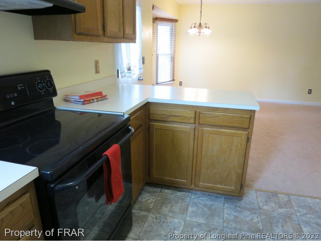 6875 Green Creek Road Fayetteville, NC 28314 - Photo 8 of 26 a kitchen with stainless steel appliances granite countertop a sink