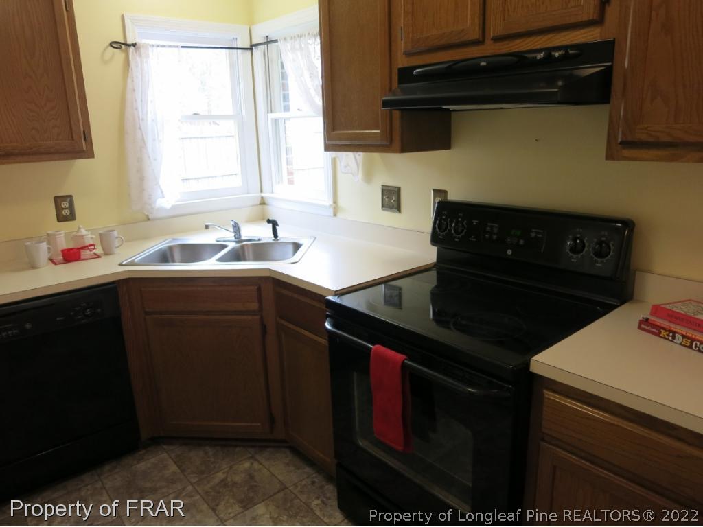 6875 Green Creek Road Fayetteville, NC 28314 - Photo 9 of 26 a kitchen with a sink stove and cabinets