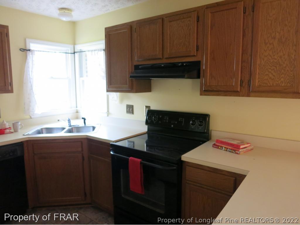 6875 Green Creek Road Fayetteville, NC 28314 - Photo 10 of 26 a kitchen with a sink and cabinets