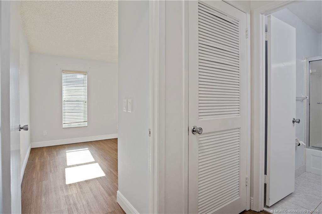 6531 Southeast Federal Highway, Unit N106 Stuart, FL 34997 - Photo 18 of 35 a view of empty room with wooden floor and window