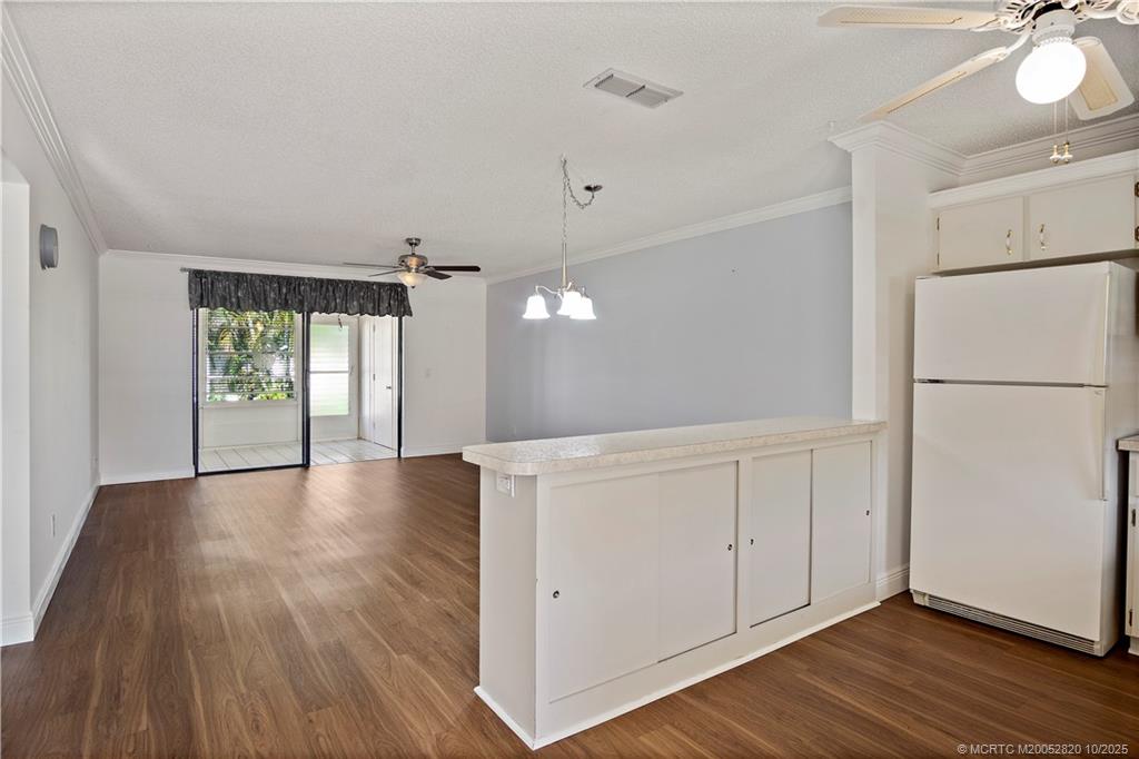 6531 Southeast Federal Highway, Unit N106 Stuart, FL 34997 - Photo 6 of 35 a view of a kitchen with a white cabinet and a refrigerator