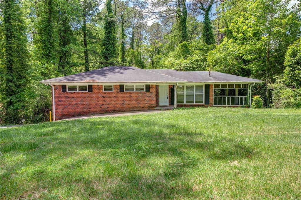 2717 Rockcliff Road Southeast Atlanta, GA 30316 - Photo 1 of 1 a front view of a house with a garden and trees