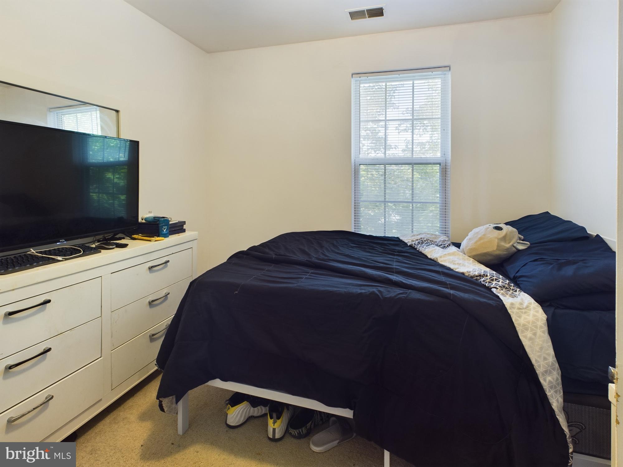 9620 Button Buck Circle Randallstown, MD 21133 - Photo 14 of 32 a bedroom with a bed and a flat screen tv