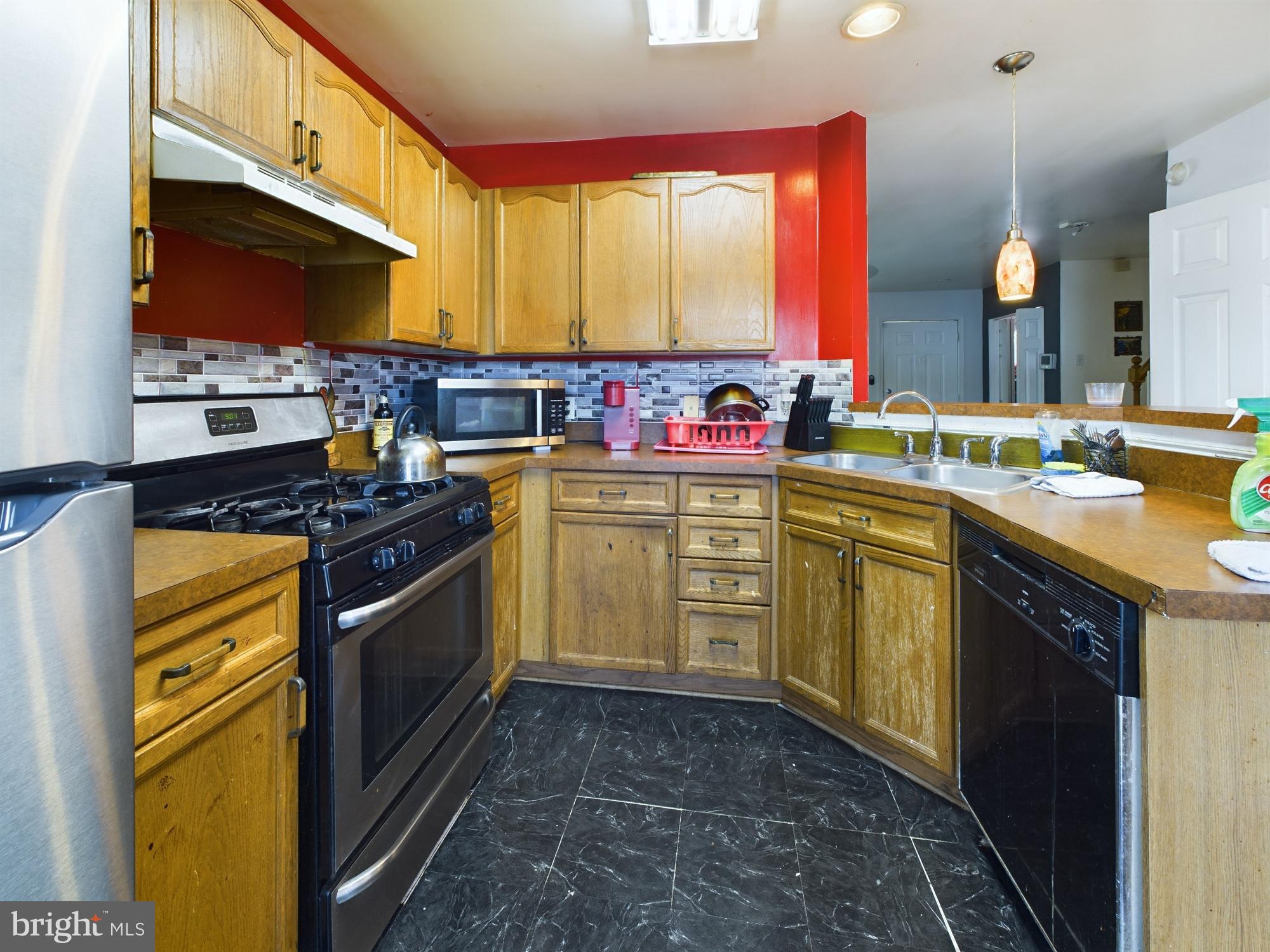 9620 Button Buck Circle Randallstown, MD 21133 - Photo 9 of 32 a kitchen with a sink stove and cabinets