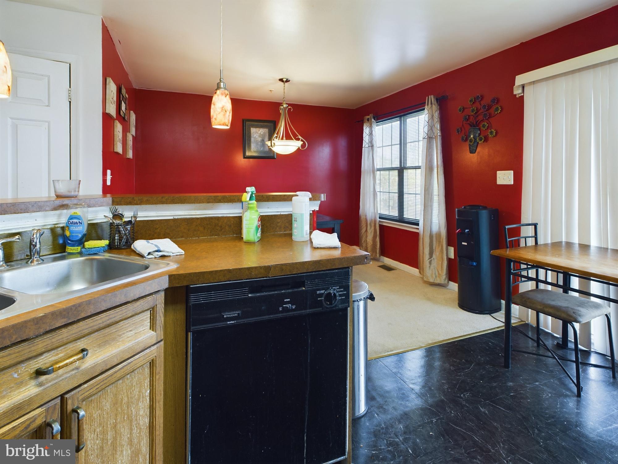 9620 Button Buck Circle Randallstown, MD 21133 - Photo 10 of 32 a kitchen with a wooden table and chairs